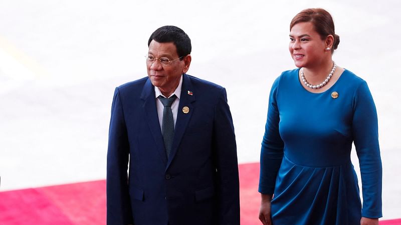 Philippine president Rodrigo Duterte (L) and his daughter Sara Duterte