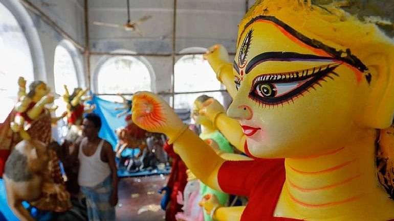 Artisans are passing busy time with the finishing touches ahead of Durga Puja