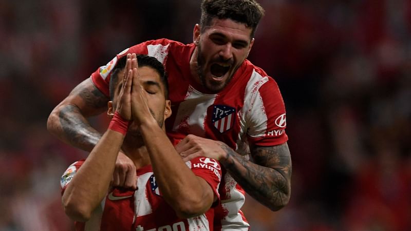 Atletico Madrid's Uruguayan forward Luis Suarez (L) celebrates after scoring a goal during the Spanish League football match between Club Atletico de Madrid and FC Barcelona at the Wanda Metropolitano stadium in Madrid on 2 October, 2021