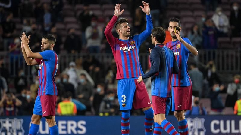 Barcelona's Spanish defender Gerard Pique (C) celebrates with teammates at the end of the Spanish league football match between FC Barcelona and Valencia CF at the Camp Nou stadium in Barcelona on 17 October, 2021