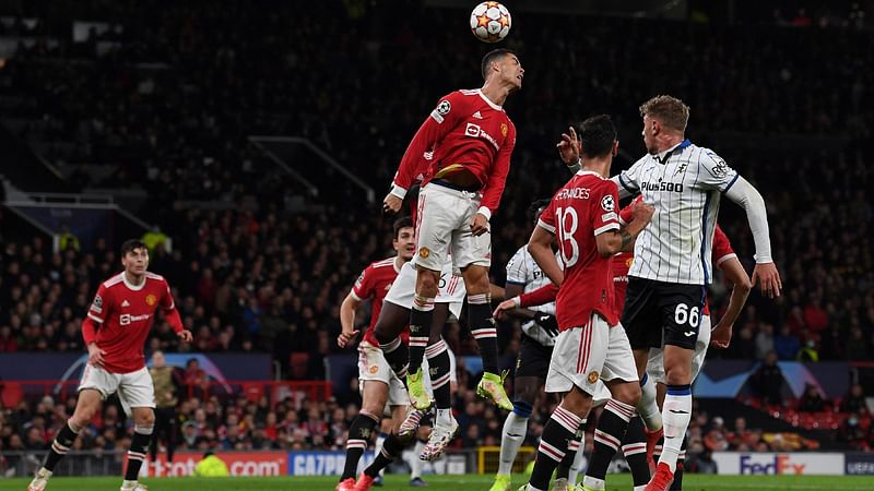 Manchester United's Portuguese striker Cristiano Ronaldo jumps to header the ball during the UEFA Champions league group F football match between Manchester United and Atalanta at Old Trafford stadium in Manchester, north west England, on 20 October, 2021