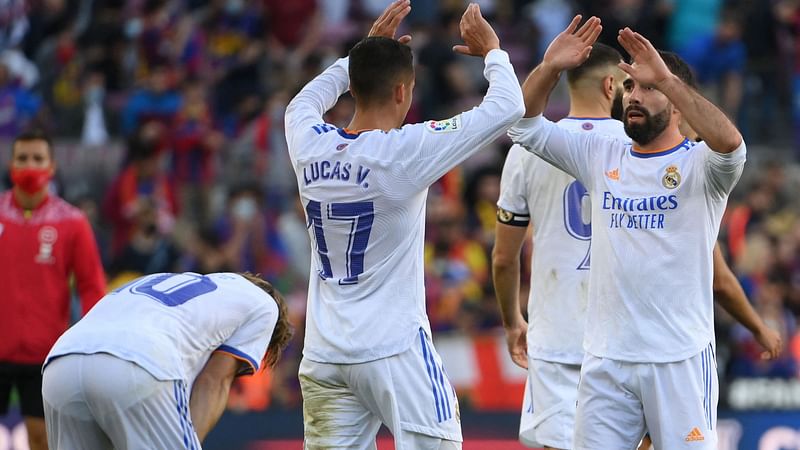 Real Madrid's players celebrate after the Spanish League football match between FC Barcelona and Real Madrid CF at the Camp Nou stadium in Barcelona on 24 October, 2021