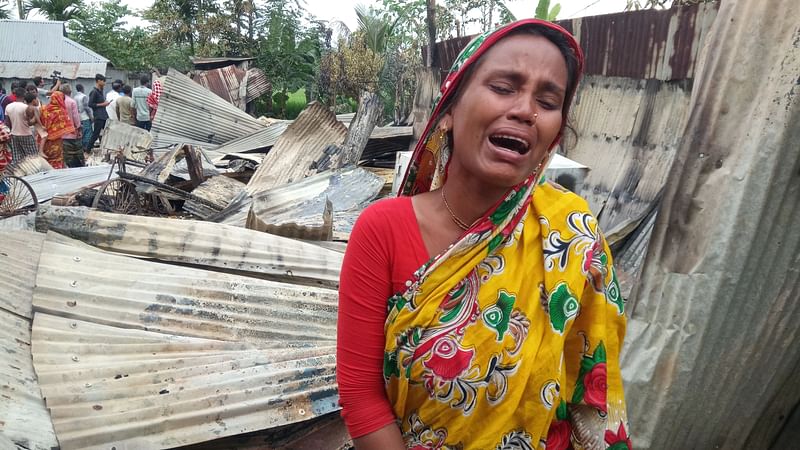 Nanda Rani wails in front her house torched Sunday night by a group of miscreants. The picture was taken from Pirganj in Rangpur on 18 October.