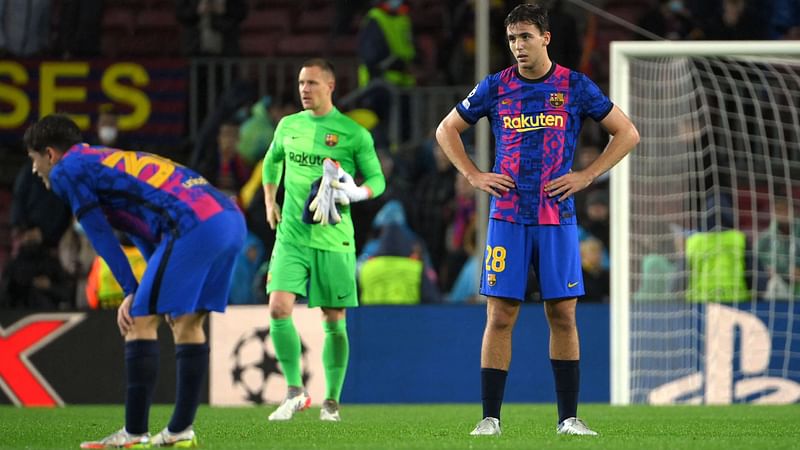 Barcelona's Spanish midfielder Nico Gonzalez (R) reacts at the end of the UEFA Champions League Group E football match between FC Barcelona and SL Benfica, at the Camp Nou stadium in Barcelona on 23 November, 2021