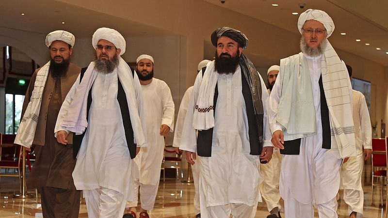 In this file photo taken on 12 August 2021, Head of the Taliban delegation Abdul Salam Hanafi (R), accompanied by Taliban officials (2R to L) Muttaqi, Shahabuddin Delawar and Abdul Latif Mansour, walks down a hotel lobby during the talks in Qatar's capital Doha