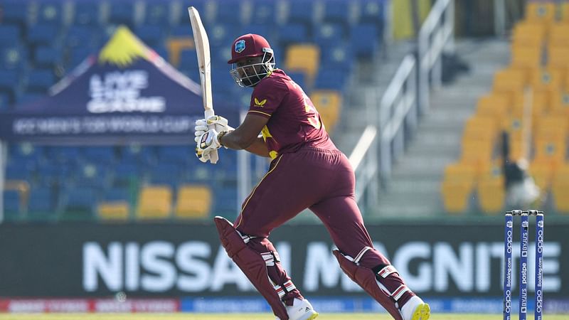 West Indies' Kieron Pollard (R) plays a shot during the ICC men's Twenty20 World Cup cricket match between Australia and West Indies at the Sheikh Zayed Cricket Stadium in Abu Dhabi on 6 November 2021.