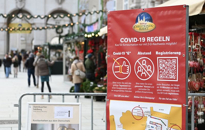 A sign displays rules for a visit of the christmas market amid the novel coronavirus COVID-19 pandemic in Salzburg, on 19 November, 2021