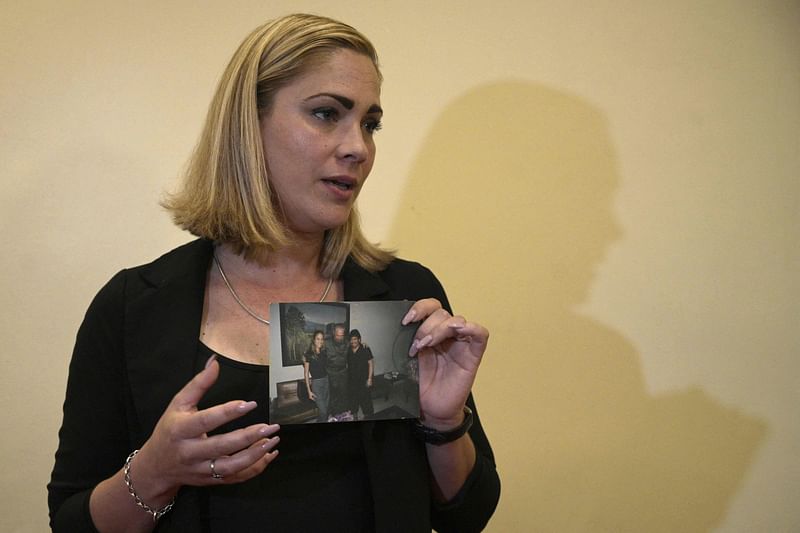 Cuban Mavys Alvarez, who had a sentimental relationship with late Argentine football star Diego Maradona (1960 - 2020) when she was a minor, displays a photo with late Cuban leader Fidel Castro and Maradona, after delivering a press conference to international news agencies in Buenos Aires, Argentina on 22 November, 2021