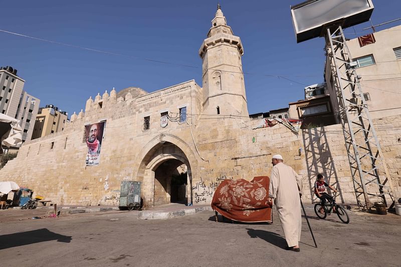 Palestinian survivor of Israel's first military incursion in Gaza 65 years ago, Bassam Barbakh, walks in front of Khan Yunis's 13th Century Barquq Castle where he said dozens of bodies killed by Israeli troops were left outside the castle walls, in Khan Yunis in the Gaza Strip, on 18 July 2021