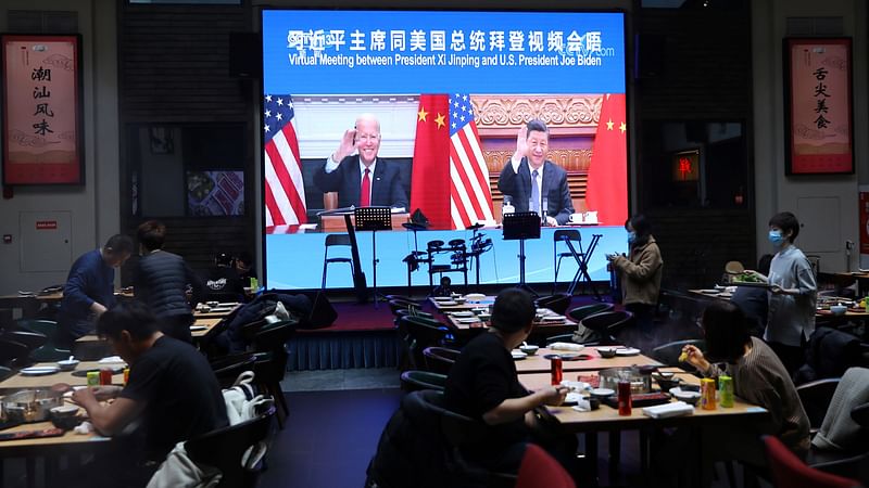 A screen shows Chinese president Xi Jinping attending a virtual meeting with U.S. president Joe Biden via video link, at a restaurant in Beijing, China on 16 November 2021