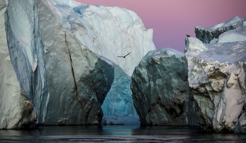 Icebergs are seen at the mouth of the Jakobshavn ice fjord during sunset near Ilulissat, Greenland, on 16 September 2021