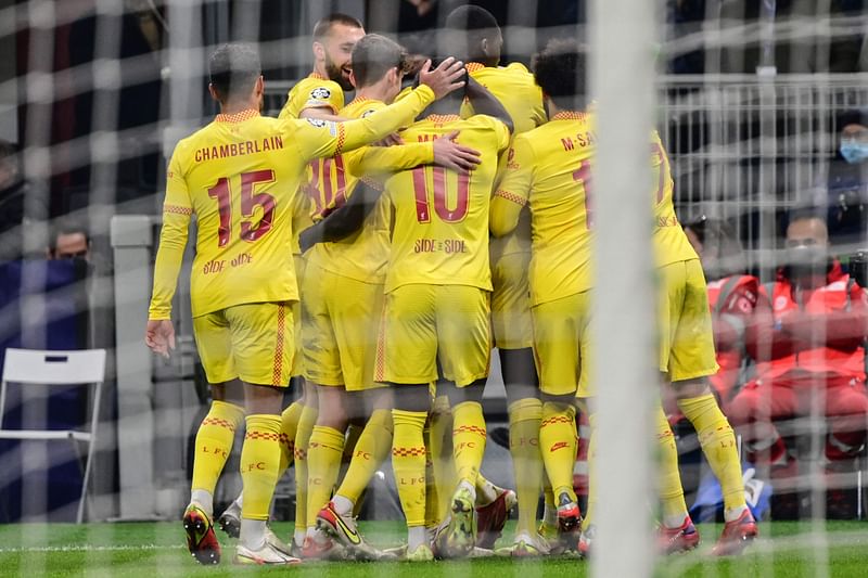 Liverpool players celebrate after scoring their second goal during the UEFA Champions League Group B football match between AC Milan and Liverpool on 7 December, 2021 at the San Siro stadium in Milan