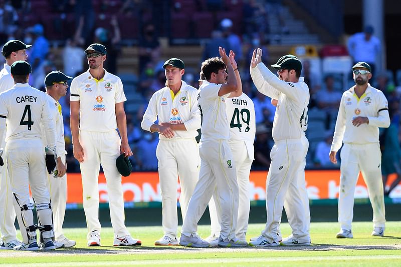 Australia's paceman Jhye Richardson (C) celebrates his wicket of England's batsman Chris Woakes (not pictured) with teammates on the last day of the second cricket Test match of the Ashes series between Australia and England at Adelaide Oval on 20 December, 2021