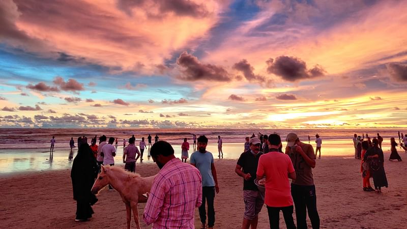 Tourists roaming on the sea beach in Cox's Bazar, Bangladesh