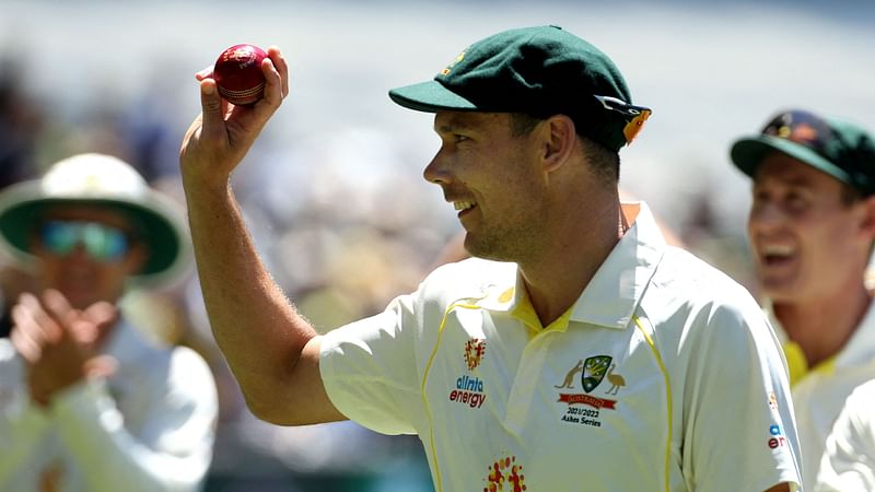 Player of the match Australia's Scott Boland celebrates with the ball on a lap of the ground after Australia won the match and retained the Ashes at the end of the third Ashes cricket Test match between Australia and England in Melbourne on 28 December, 2021