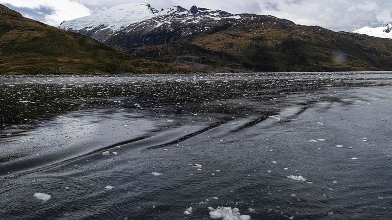 Fragments of ice float on the water of Fouque fjord at the Beagle Channel in Chile, on 30 November, 2021