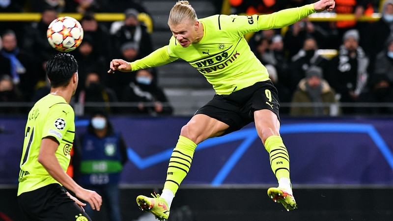 In this file photo taken on 7 December, 2021 Dortmund's Norwegian forward Erling Haaland heads the ball to score his team's fourth goal during the UEFA Champions League Group C football match against Besiktas in Dortmund