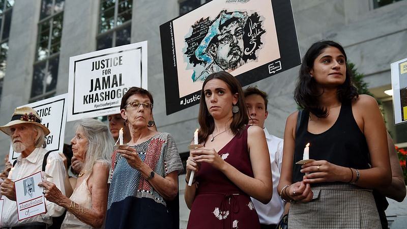 In this file photo taken on 1 October 2019, people gather in front of the Embassy of Saudi Arabia in Washington, DC, to remember Jamal Khashoggi, a Saudi journalist and a Washington Post contributing columnist, killed by a team of assassins at the Saudi Arabian consulate in Istanbul