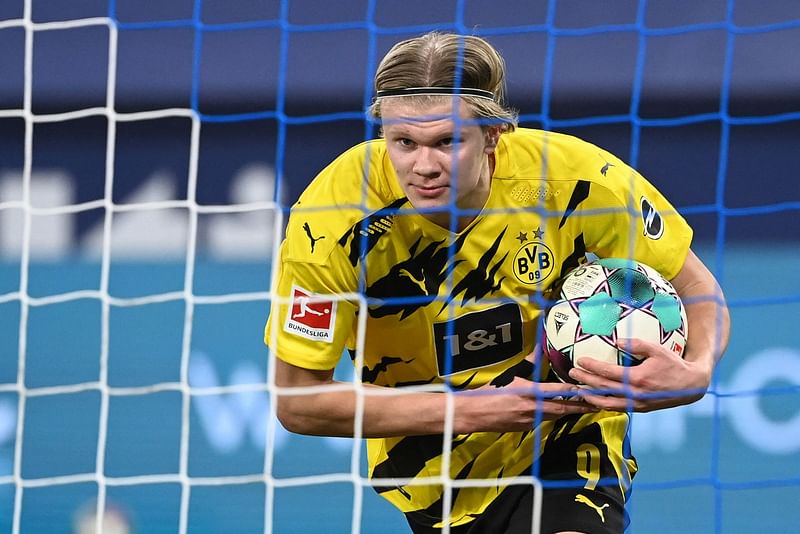 In this file photo taken on 20 February, 2021 Dortmund's Norwegian forward Erling Braut Haaland celebrates scoring the fpurth goal during a Bundesliga football match against FC Schalke 04 in Gelsenkirchen