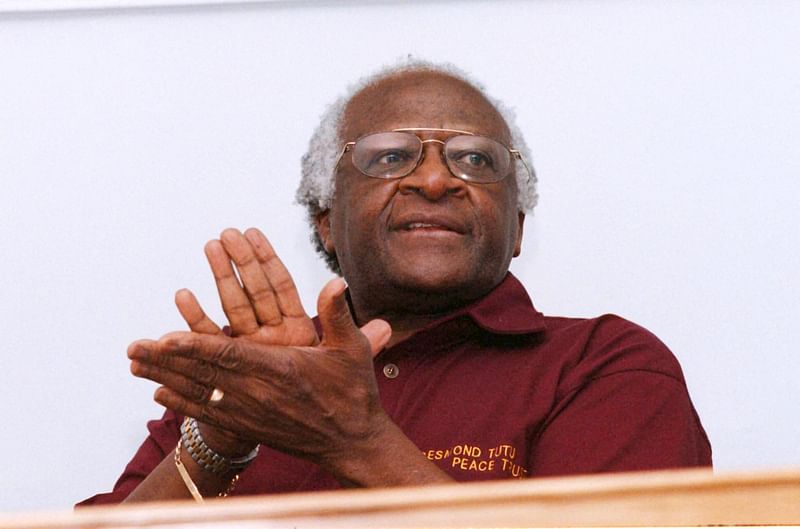 In this file photo taken on 27 October 1998 Truth and Reconciliation Commission (TRC) chairman Archbishop Desmond Tutu claps at the end of the press conference which concludes the activities of the TRC at the TRC offices in Cape Town