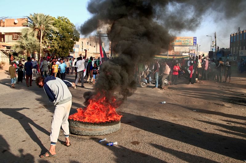 Demonstrators gather during a protest demanding civilian rule in the Sudanese capital's twin city of Omdurman on 13 December, 2021