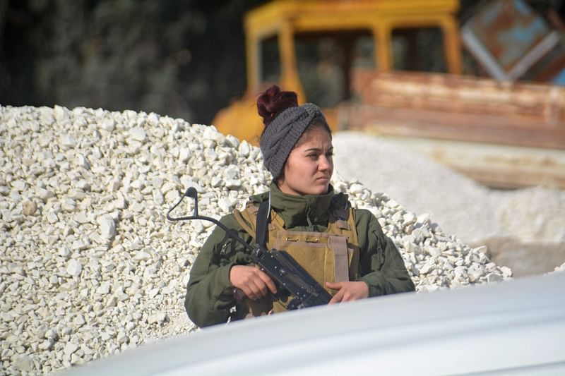 A member of the Syrian Democratic Forces (SDF) mans a checkpoint in the northern Syrian city of Hasakeh on 23 January, 2022