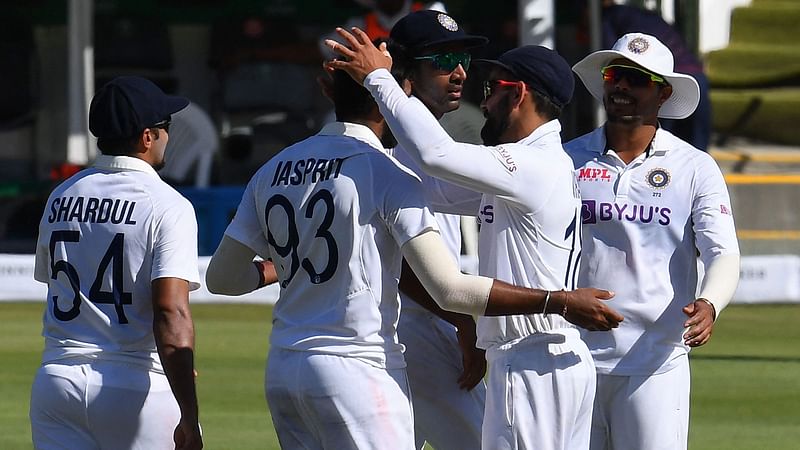 India's Jasprit Bumrah (2nd L) celebrates with teammates after the dismissal of South Africa's Lungi Ngidi (not seen) during the second day of the third Test cricket match between South Africa and India at Newlands stadium in Cape Town on 12 January, 2022