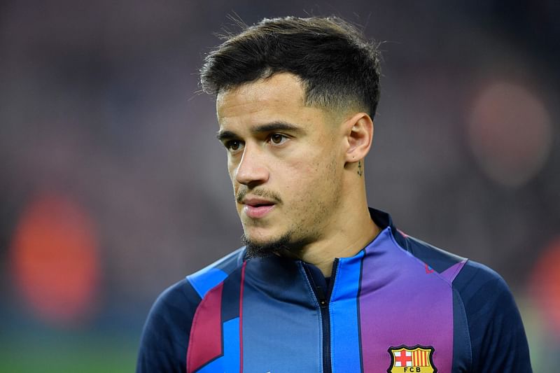 In this file photo taken on 18 December, 2021 Barcelona's Brazilian midfielder Philippe Coutinho warms up before the Spanish league football match between FC Barcelona and Elche CF