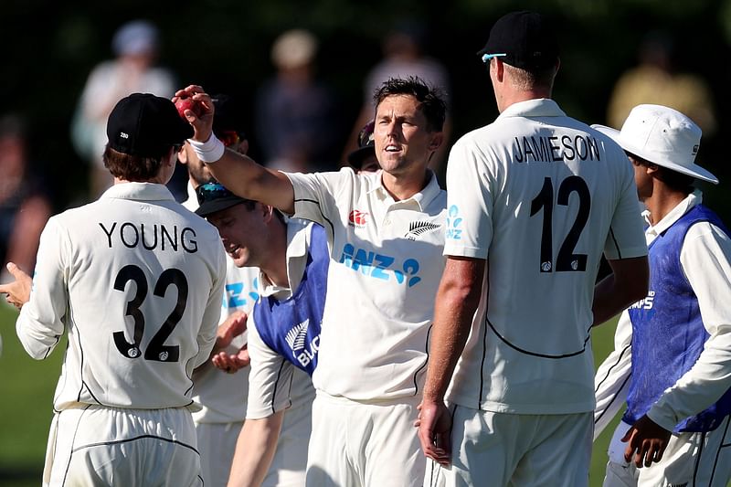 New Zealand's Trent Boult (C) celebrates taking his 300th test wicket on day two of the second cricket test match between New Zealand and Bangladesh in Christchurch on 10 January, 2022.