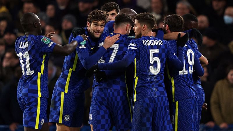 Chelsea players celebrate after Tottenham Hotspur's Welsh defender Ben Davies (unseen) scored an own goal during the English League Cup semi final football match between Chelsea and Tottenham Hotspur at Stamford Bridge, in London on 5 January, 2022