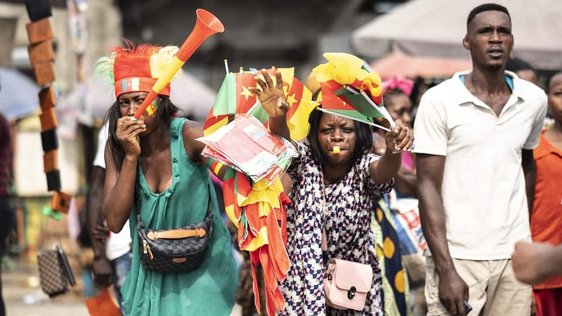 Cameroon football fans are pictured in a street in Douala on 9 January 2022. The opening match in the Africa Cup of Nations (CAN) will be played at Stade d'Olembé in Yaounde on 9 January 2022, between Cameroon and Burkina Faso.