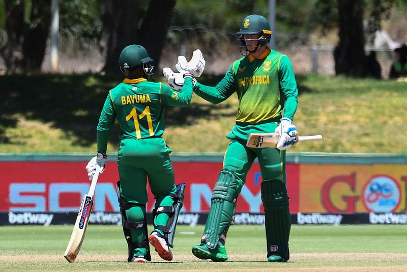 South Africa's Temba Bavuma (L) and South Africa's Rassie van der Dussen (R) celebrate their 150 run partnership during the first ODI cricket match between South Africa and India at Boland Park in Paarl on 19 January, 2022