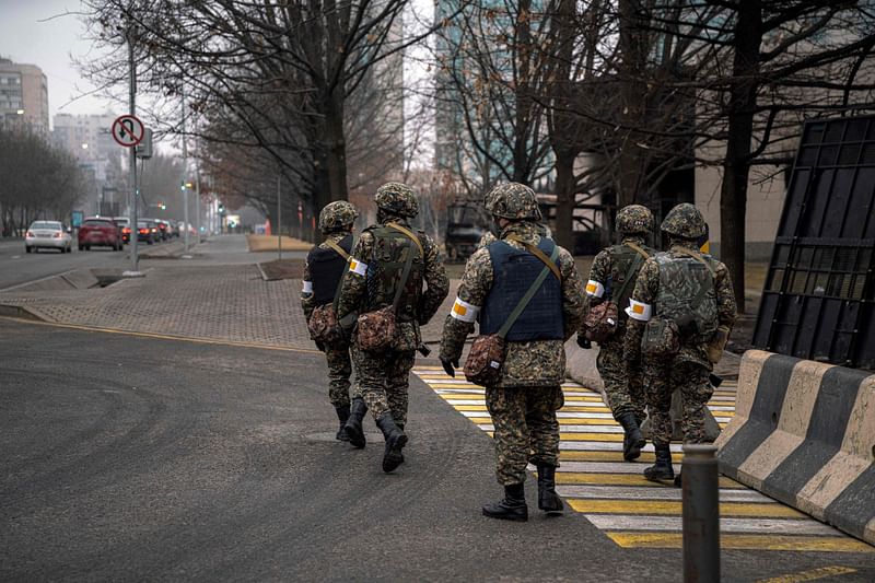 Kazakh soldiers patrol down a street in Almaty on 10 January, 2022, after the violence that erupted following protests over hikes in fuel prices