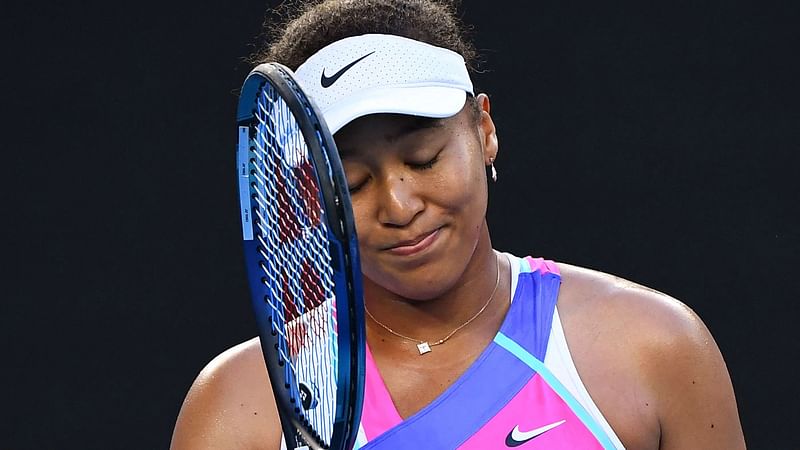 Japan's Naomi Osaka reacts as she plays against Amanda Anisimova of the US during their women's singles match on day five of the Australian Open tennis tournament in Melbourne on 21 January, 2022