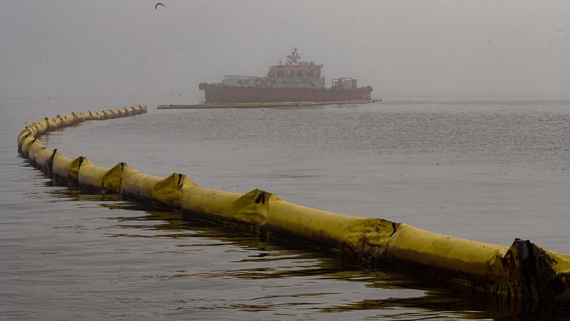 Floating barriers to protect the beaches from drifting oil are seen at the resort town of Ancon, Peru, on 21 January, 2022