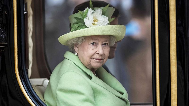 Britain`s Queen Elizabeth II looks out of the Diamond Jubilee State Coach as she travels in central London