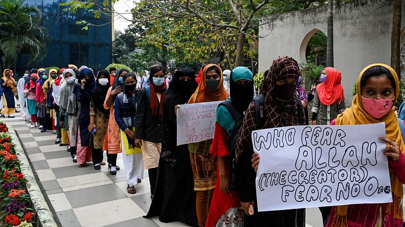 Students carrying placards take part in a demonstration in Kolkata on 9 February 2022, to protest after students at government-run high schools in India's Karnataka state were told not to wear hijabs in the premises of the institute.