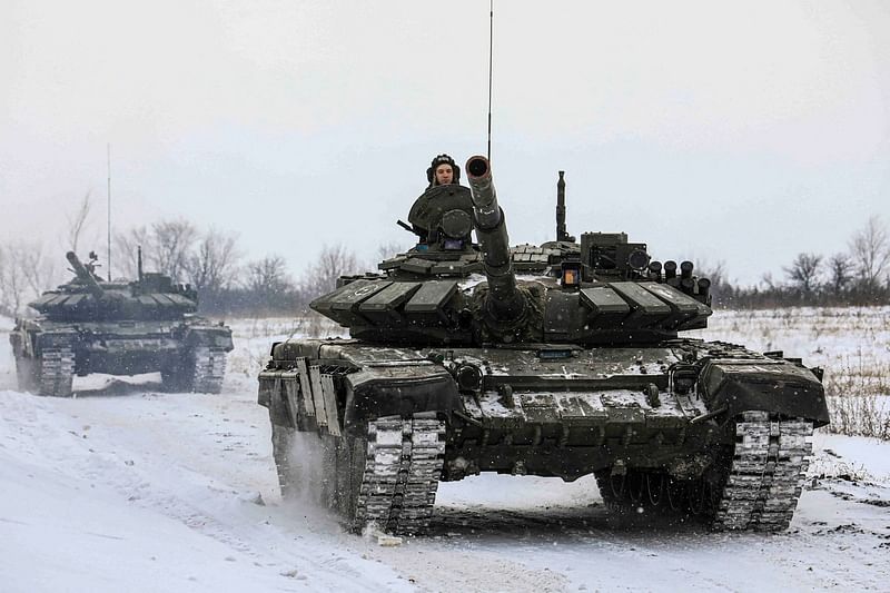 Russian servicemen drive tanks during military exercises in the Leningrad Region, Russia, in this handout picture released 14 February, 2022