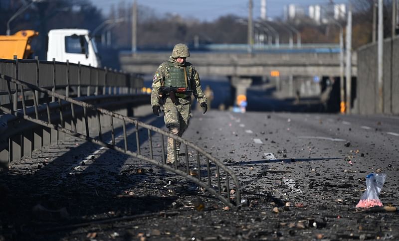 An Ukrainian soldier walks through debris on the west side of the Ukrainian capital of Kyiv on 26 February, 2022