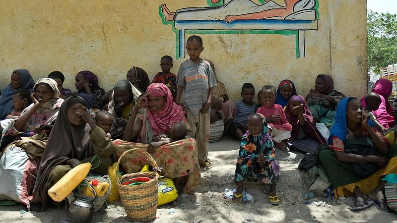 In this file photo taken on 14  February 2012 internally displaced Somalis wait for food aid rations near a distribution centre in war-torn capital, Mogadishu.