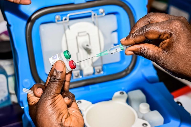 In this file photo taken on 13 September 2019 a health worker measures the dosage of malaria vaccine in Ndhiwa, Homabay County, western Kenya during the launch of malaria vaccine in Kenya