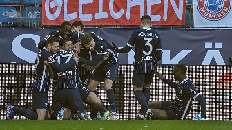 Bochum's Costa Rican defender Cristian Gamboa (3rd L) celebrates scoring the 3-1 goal with his teammates during the German first division Bundesliga football match between VfL Bochum and FC Bayern Munich in Bochum, western Germany on 12 February, 2022