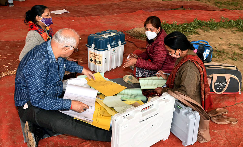 olling officials checking the Electronic Voting Machine (EVMs) and other necessary inputs required for the Uttar Pradesh Assembly Election, at a distribution centre in Ghaziabad on 9 February 2022