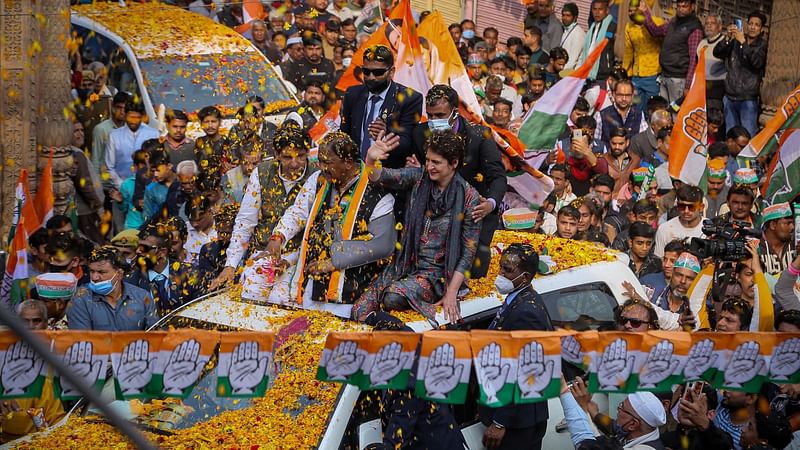 Congress party leader Priyanka Gandhi (C, atop car waving) waves to the party supporters during a road show in Mathura in India’s Uttar Pradesh state on 8 February, 2022