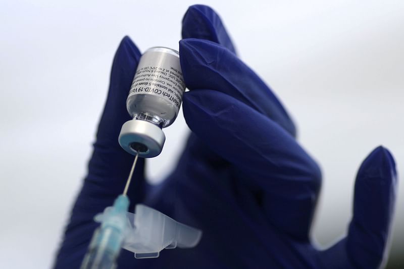 A syringe and a vial of Covid-19 vaccine