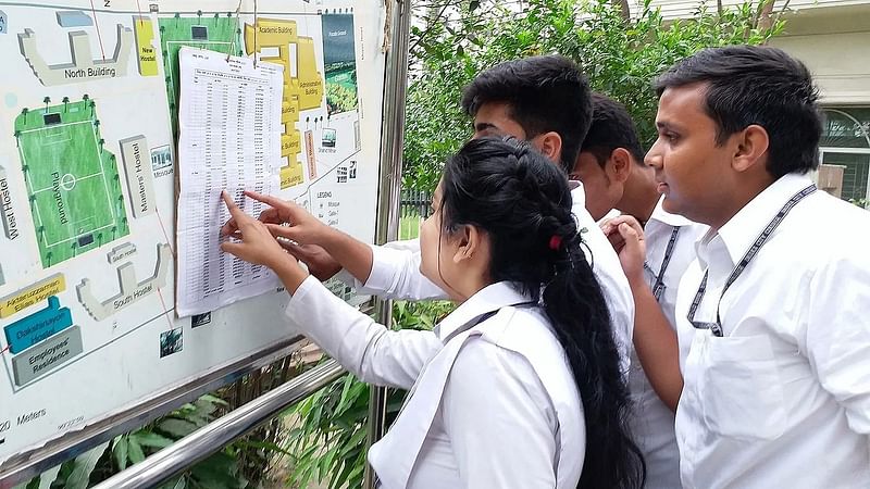 Students look for their HSC results at a college in the capital.