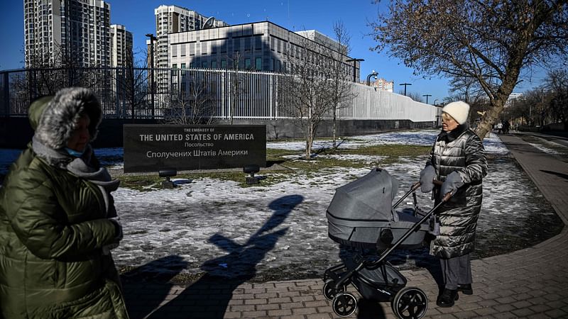 People pass by the closed US embassy in Kyiv, on 15 February  2022. American citizens have already been urged to leave Ukraine, with the West accusing Russia of sending more than 100,000 soldiers to encircle the former Soviet state.