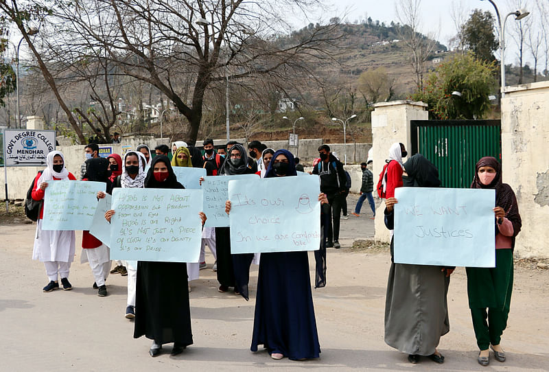 Students hold placards during a protest over the hijab ban imposed in the few colleges in Karnataka at Government Degree College, Mendhar, in Poonch district of Jammu and Kashmir on  18 February 2022