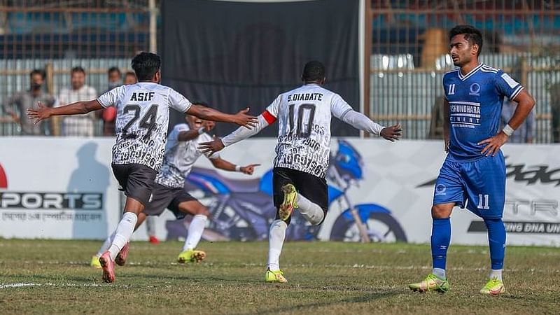 Dhaka Mohammedan's Malian striker Souleymane Diabate celebrates with teammates after scoring a goal against Sheikh Russel KC at the Shaheed Ahsanullah Master Stadium in Tongi, Gazipur on 5 February, 2022