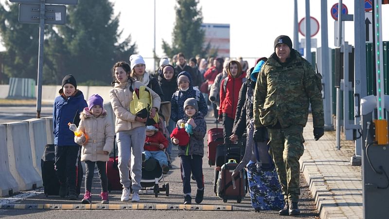 Ukrainian women and children cross the border from Ukraine to Poland at the Korczowa-Krakovets border crossing on 26 February, 2022